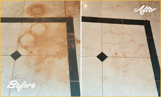 Before and After Picture of a Gold Bar Hard Surface Restoration Service on a Marble Floor to Eliminate Rust Stains